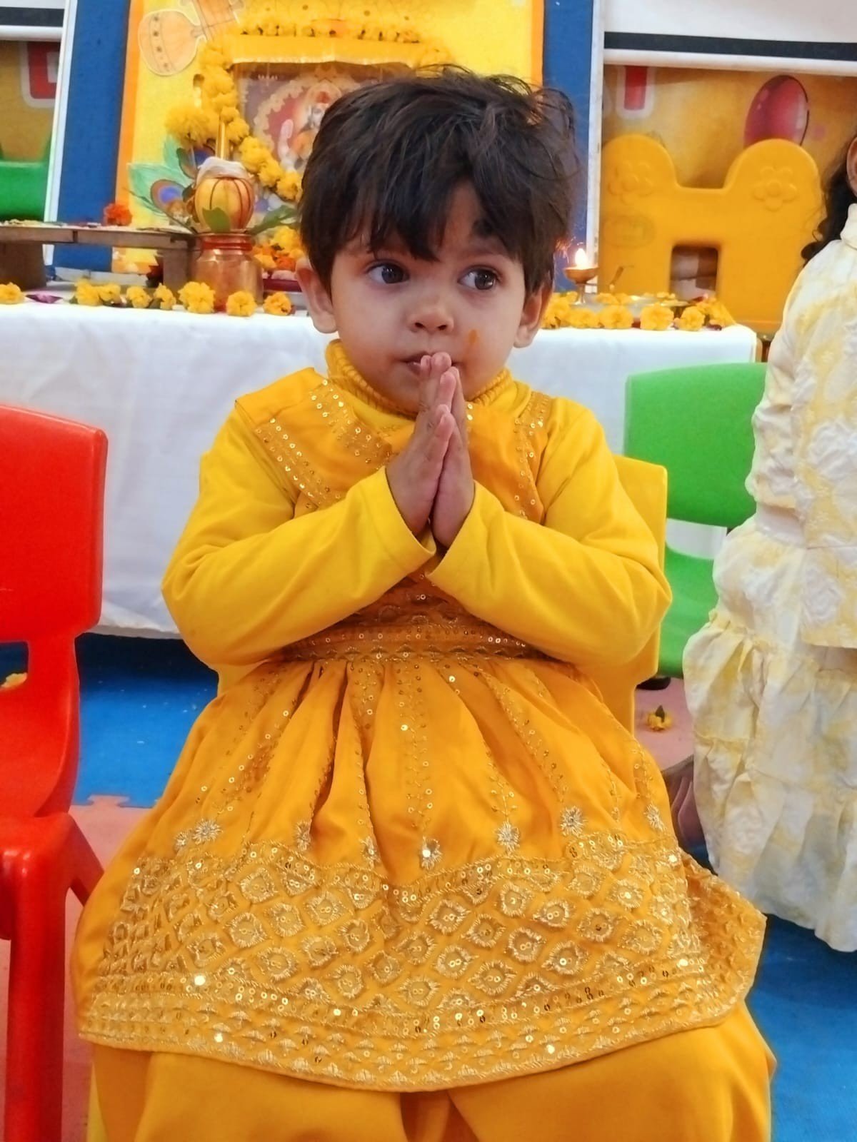 Students dressed in yellow, offering prayers on Basant Panchami